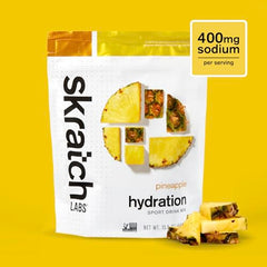 Skratch Labs Hydration Powder pineapple scoop beside bottle showing easy dosage.