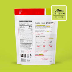 Skratch Labs hydration glass-mixing scene with raspberry limeade caffeine powder