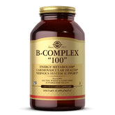Solgar B-Complex 100 bottle pour showing energy metabolism support in vegan formula.