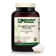 Standard Process Calcium Lactate Powder bottle on countertop for daily bone health support.