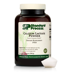 Standard Process Calcium Lactate Powder bottle on countertop for daily bone health support.