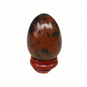 Sunshcat crystal egg on wooden bracket promotes balanced energy and calm focus.