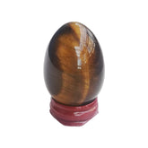 Sunshcat tiger's eye egg with warm luster on display for meditation balance.