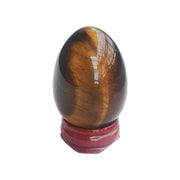 Sunshcat tiger's eye egg with warm luster on display for meditation balance.