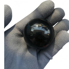 Sunshcat obsidian sphere used as desk decor in a calm workspace