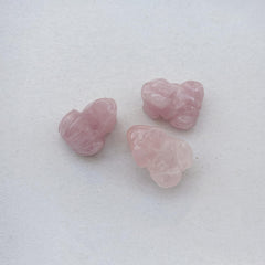 Sunshcat rose quartz frog held in hand for portable serenity and focus.