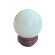 Sunshcat Synthetic Opalite ball on wooden stand for meditation and balance.