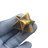 Sunshcat Tiger's Eye Merkaba hexagonal star crystal, front view, aids meditation and positive energy.
