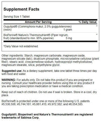 Swanson Gugulipid tablet close-up indicating easy daily supplementation with meals.