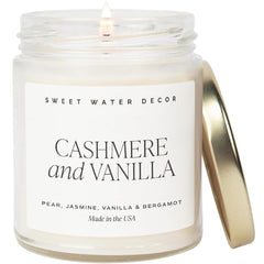 Sweet Water Decor cashmere vanilla candle in a gold-lid jar enhances cozy living room ambience.