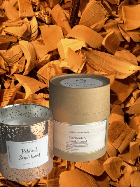 Terreux Patchouli Sandalwood candle in copper jar; close-up for meditation ambiance.