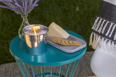Citronella candle in metal bucket creates warm ambiance and pest deterrence