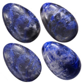 TUMBEELLUWA crystal egg held in palm to ease stress and enhance focus.