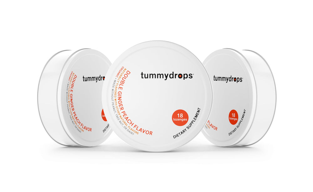 Tummy Drops Organic Double Ginger Peach tins, gluten‑free and vegan, ideal for on-the-go use.