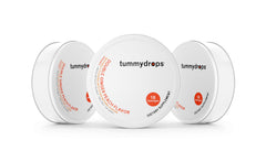 Tummy Drops Organic Double Ginger Peach tins, gluten‑free and vegan, ideal for on-the-go use.