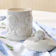 Close-up of hydrangea relief detailing on porcelain candle adds texture and sophistication.