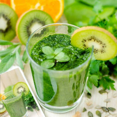 Vital All-In-One glass shows ready-to-drink lemon-ginger greens beverage.