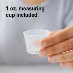 Pouring Cal-Mag Liquid into water for easy mixing during meals