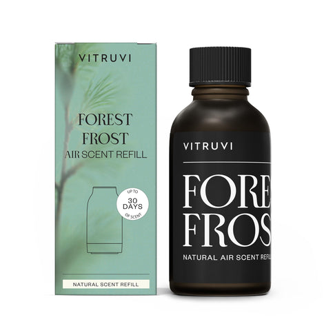 Vitruvi Forest Frost refill bottle close-up showing woodsy Fir, Cedarwood and Pine scent for calm spaces.
