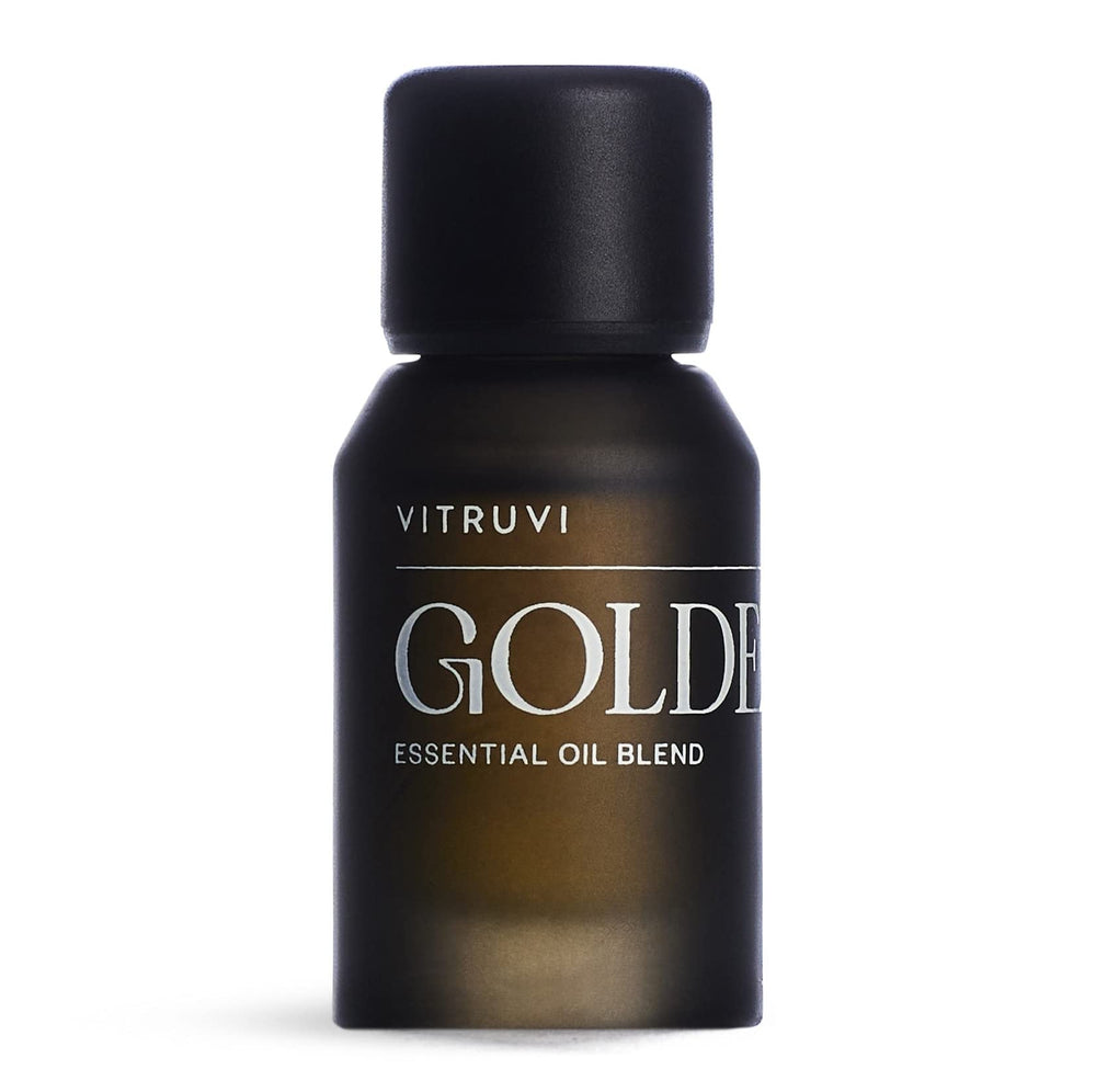 Vitruvi Golden bottle close-up showcases the citrus-spice blend for uplifting spaces