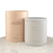 Wholesome Warm Woods candle in a concrete jar creates warm, inviting ambience.