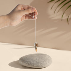 Wish Well divination pendulum in use for focused energy work.