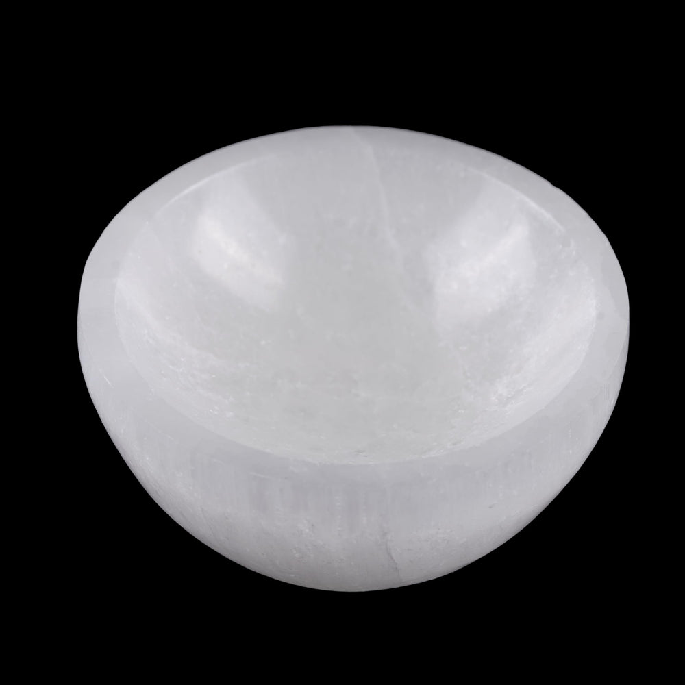 Wish Well selenite bowl on a bedside table cleanses crystals' energy overnight