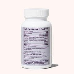 Womaness Active Glow capsules closeup featuring biotin and hyaluronic acid for hair and skin support