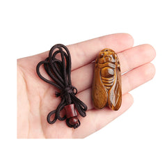 Ximimark tiger's-eye cicada pendant close-up showcasing carved details for everyday style.