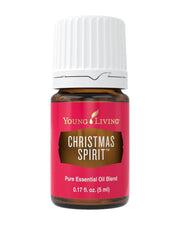 Young Living Christmas Spirit bottle pour releasing warm citrus and spice aroma.