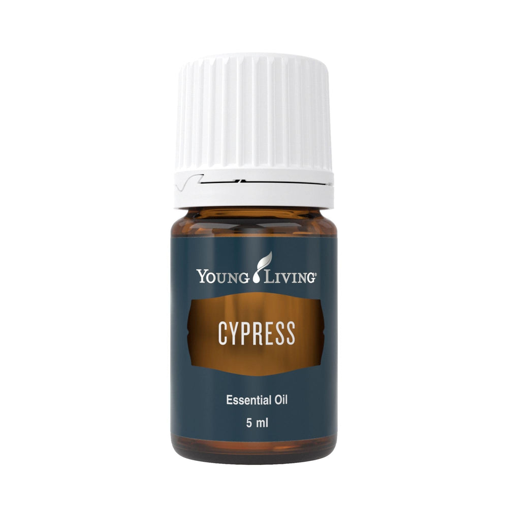 Young Living Cypress essential oil bottle pour for grounding aromatherapy.