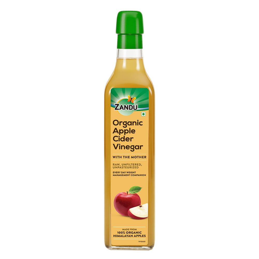 Zandu Organic Apple Cider with Mother in bottle on counter, ideal for dressings.