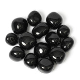ZenQ black obsidian stones in a collection, ideal for grounding rituals.