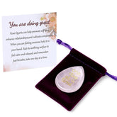 ZHIYUXI One Day at a Time rose quartz worry stone held in hand for focus and calm.
