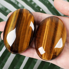 ZHIYUXI tiger's eye palm stone held in hand for grounding and concentration