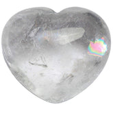 Zungtin healing crystal heart palm stone held in hand for meditation and balance.