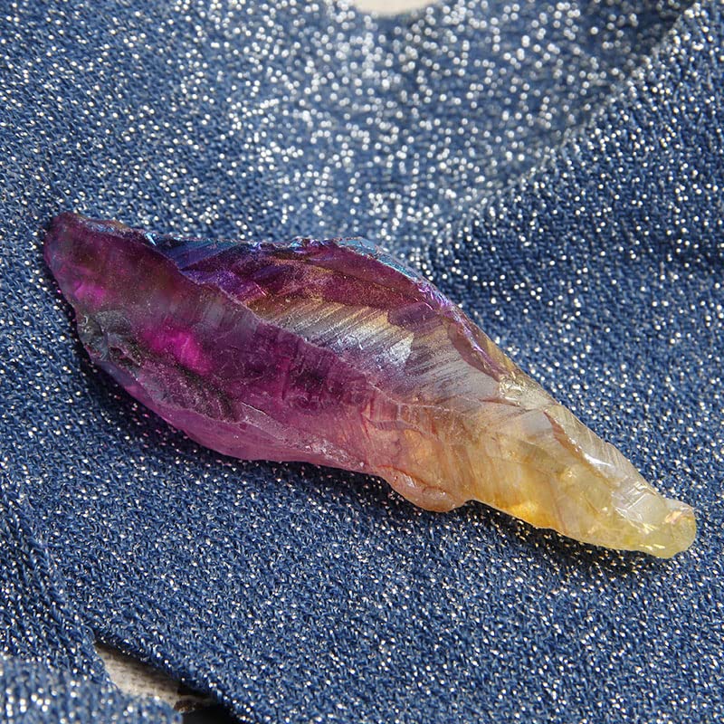 Acxico crystal point closeup shows rainbow hue for crystal work and focus.