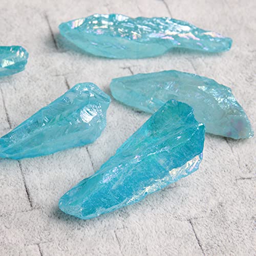 Acxico Rainbow Aura Lemurian Quartz blue crystal point captures light on display shelves