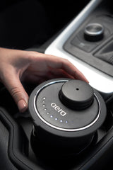 Sleek black Aera Go diffuser mounted in vehicle interior