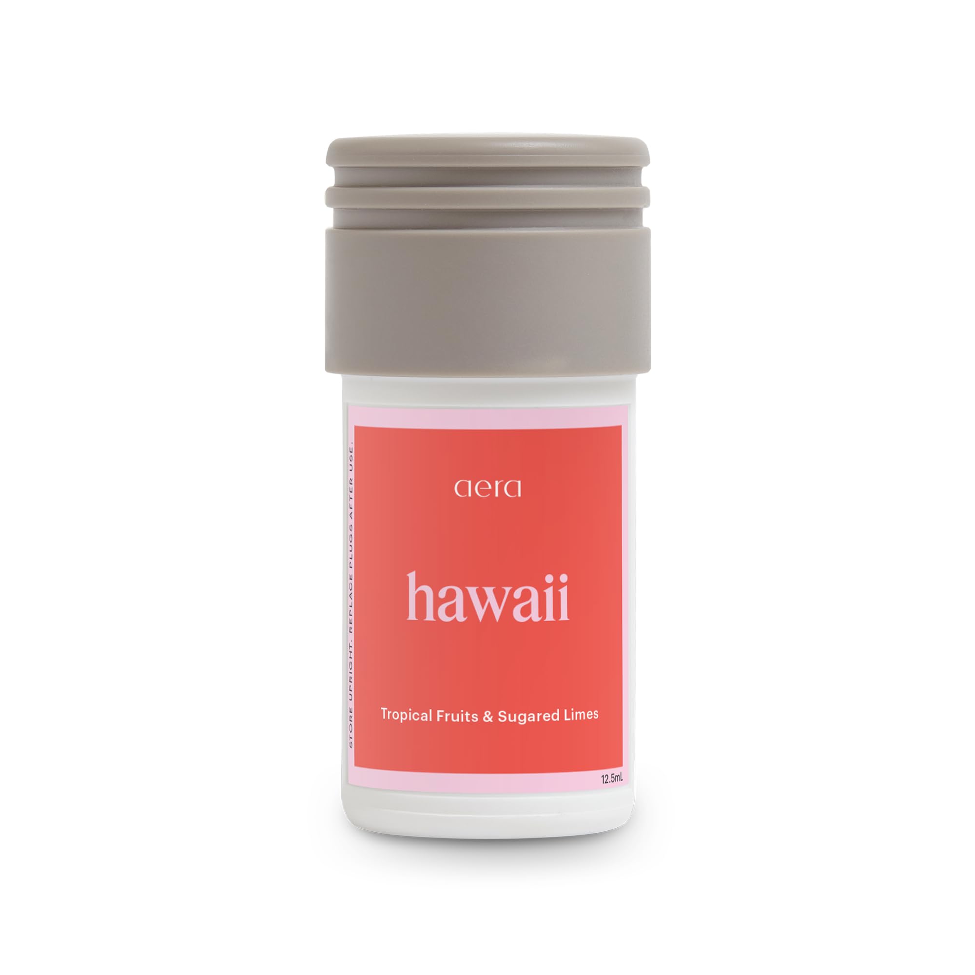 Aera Mini Destinations Hawaii bottle releasing tropical fragrance for home ambiance.