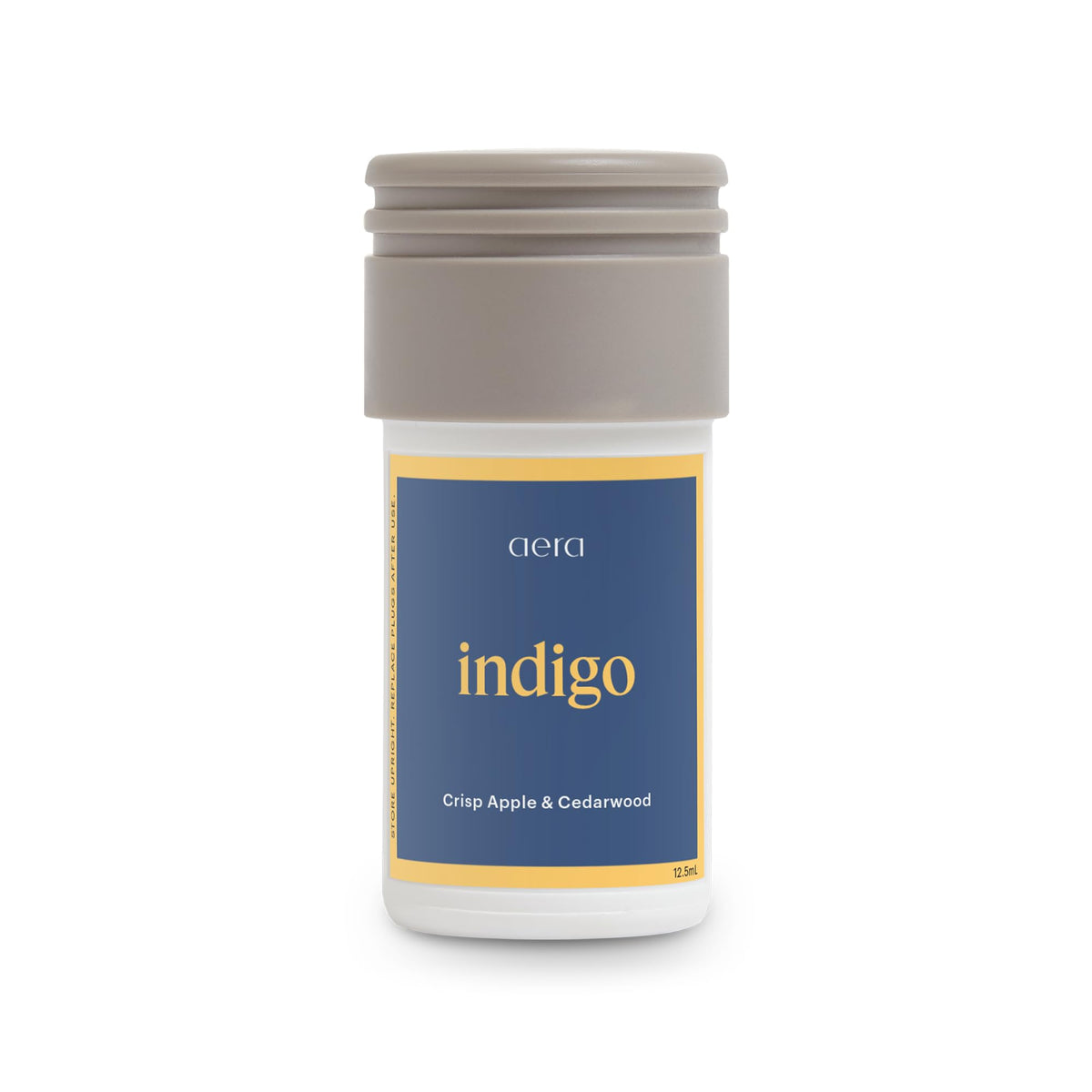Aera Mini Indigo bottle pour releases coastal cedarwood scent for living spaces.