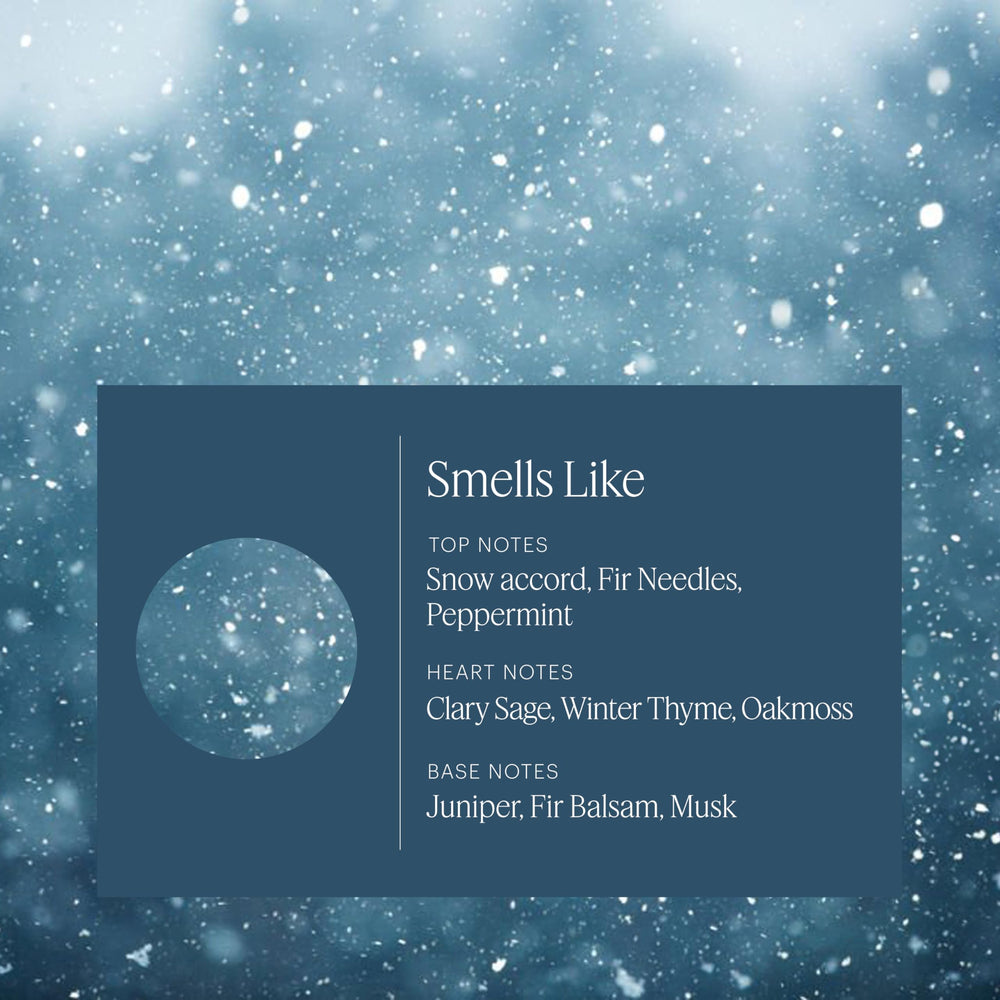 Close-up of Snowfall bottle side view highlighting the wintry aroma blend.