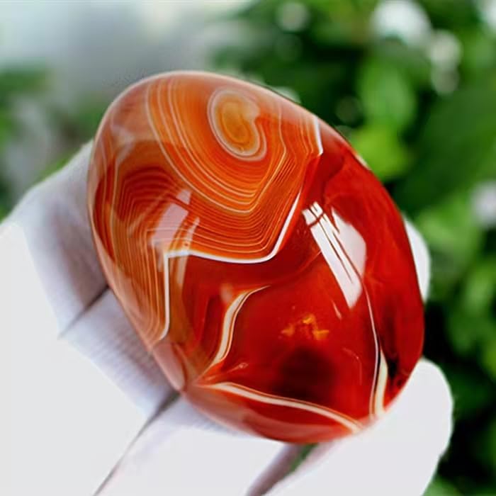 AierCrystal smooth-polished agate held in hand for relaxation and focus
