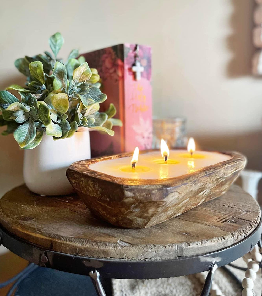 Aira hand-carved wood bowl candle adds artisanal charm.