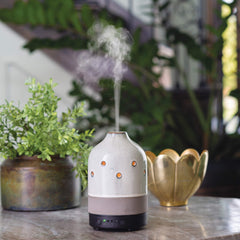 Airome ceramic diffuser side view highlighting compact form for easy placement.