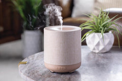 Airome Diffuser with 8-color LED lights creates ambient mood lighting.
