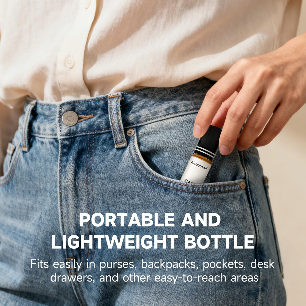 Airoomoil Calm travel-size bottle shown in hand for easy packing