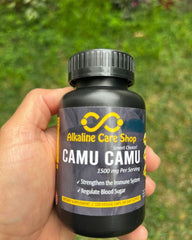 Alkaline Care Camu Camu capsules pouring for daily use.