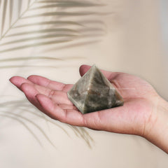 Amazing Gemstone Chrysoberyl Cats Eye Pyramid on a desk as serene decor.