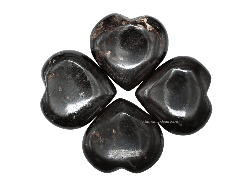 Amazing Gemstone Garnet heart palm stone enhances crystal grid setups for focus.